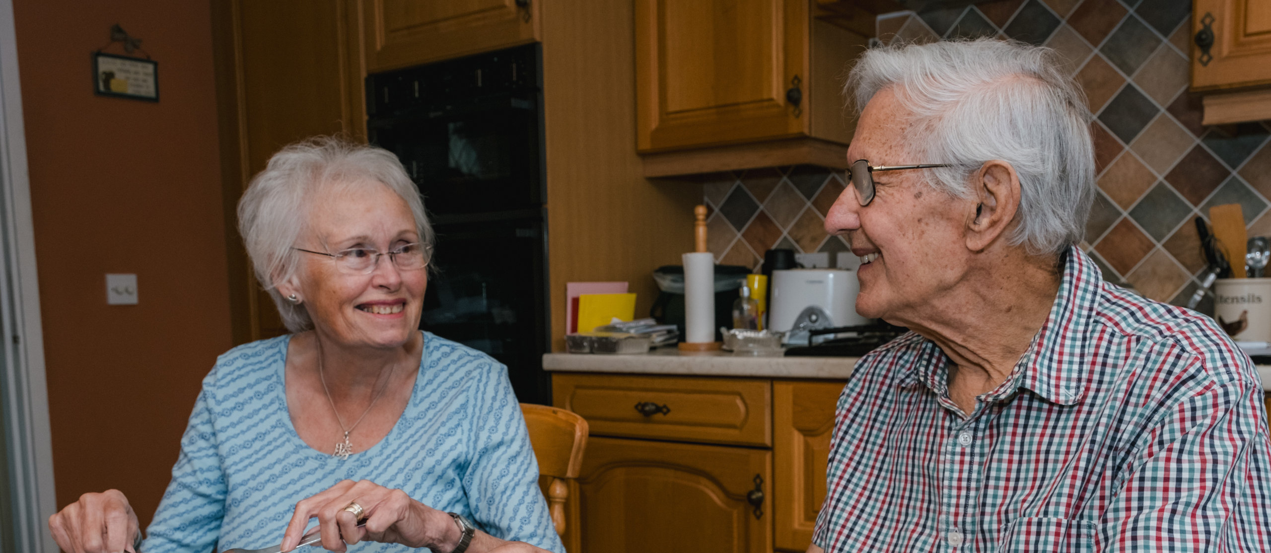 A photograph of a couple eating together