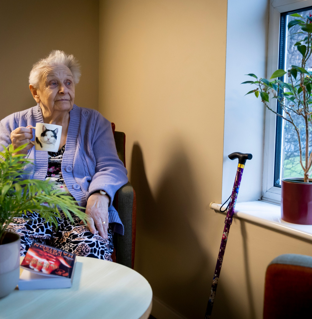 A photograph of a woman waiting for her meal