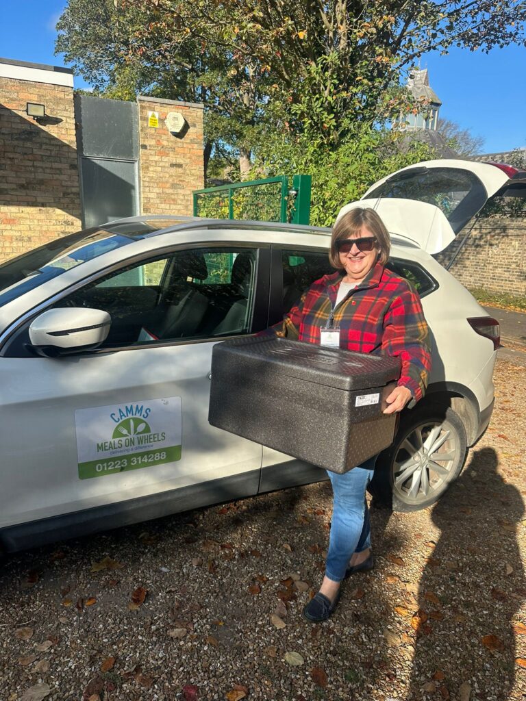 One of the CAMMS Meals on Wheels Ltd drivers preparing to deliver meals in the community
