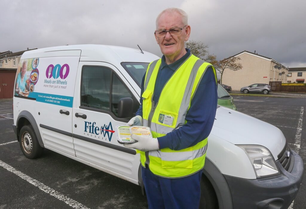 Alan, one of Fife's Meals on Wheels Drivers, proudly showing off his bespoke delivery van