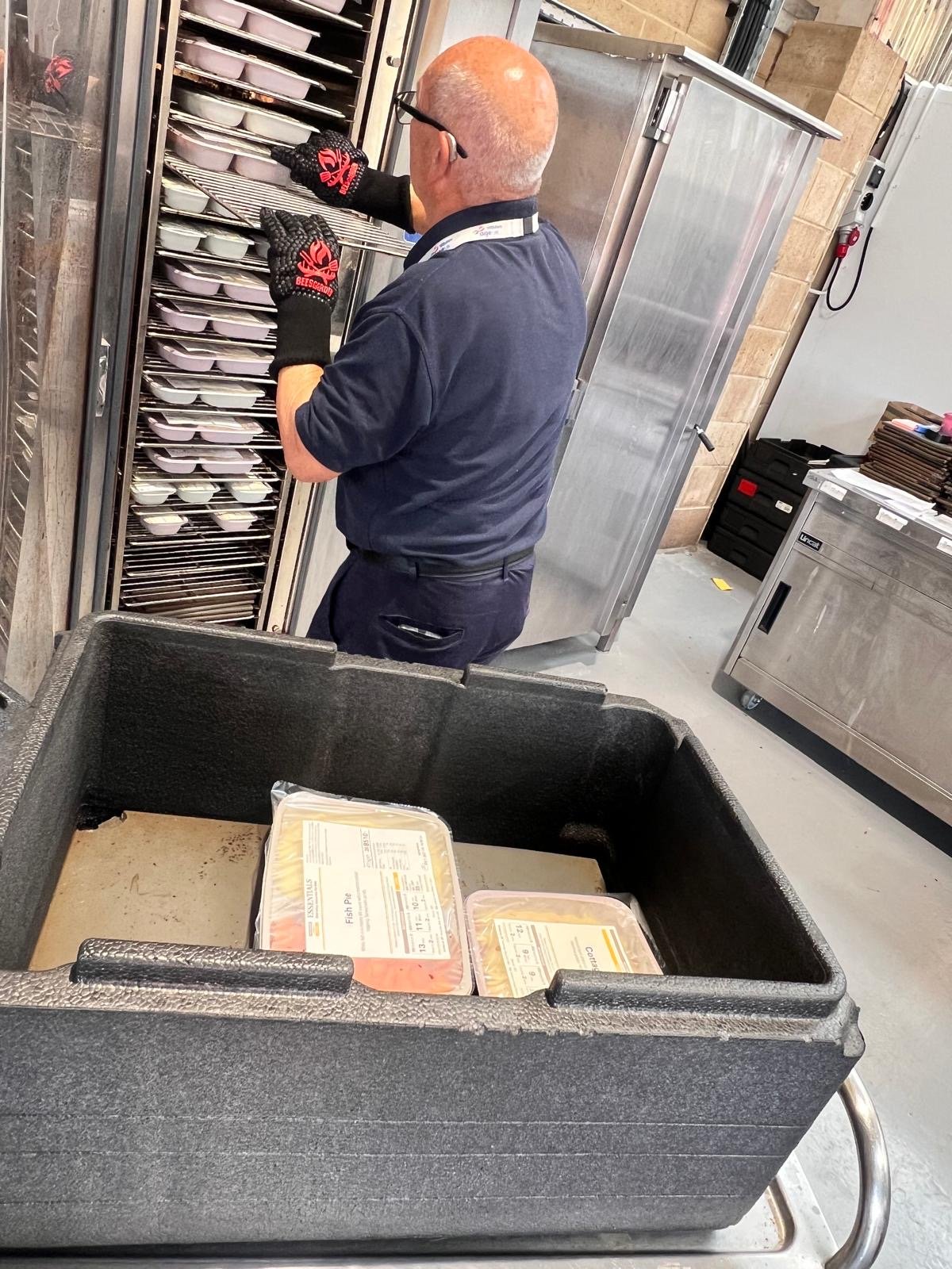 A man prepares hot meals for the delivery round